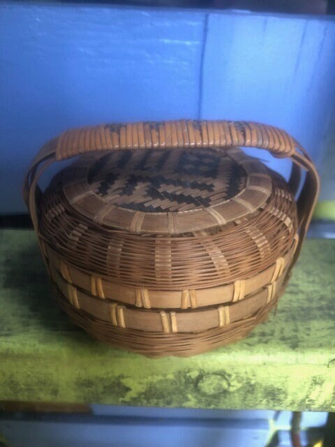 Vintage petite woven wicker basket with geometric design on handle and lid